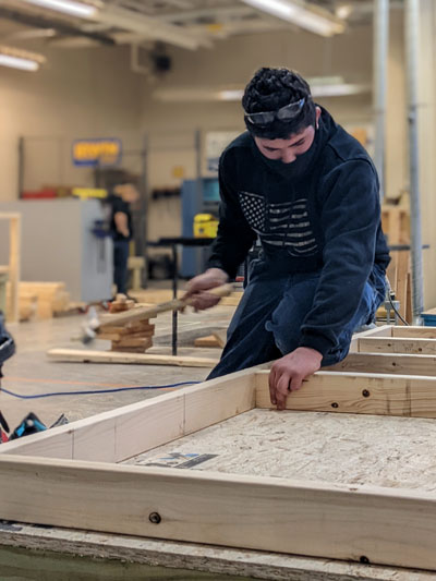 Carpentry II rebuilding backstop at Riverside